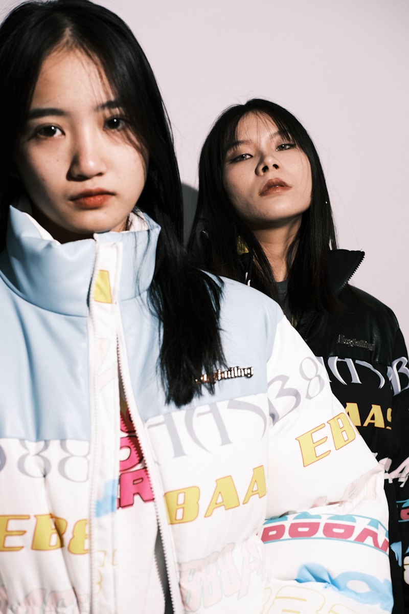 two asian women standing next to each other